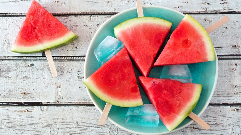Watermelon popsicle slices on teal plate
