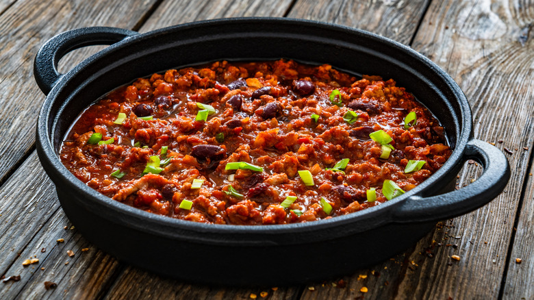 Chili con carne in a black cast iron pan with two handles