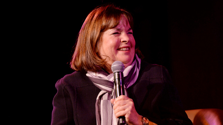 Ina Garten smiles on stage with a microphone