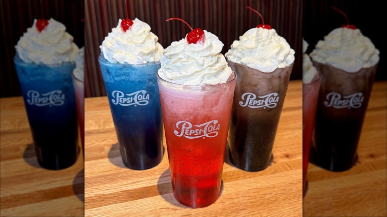 A round of tropical drinks rest on a table at Applebee's