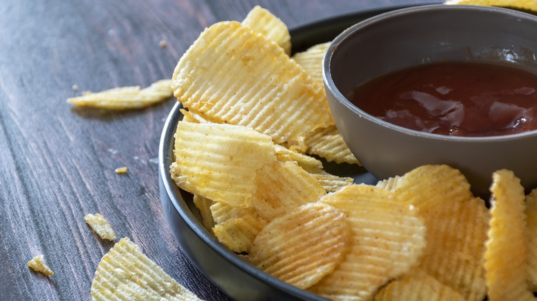 Ketchup with chips in a bowl on a counter