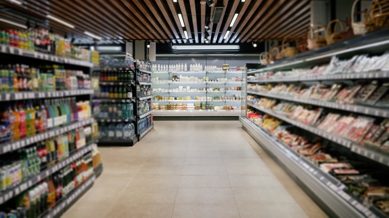 A supermarket aisle appears somewhat dim