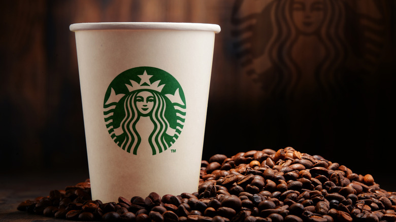 Starbucks cup and coffee beans