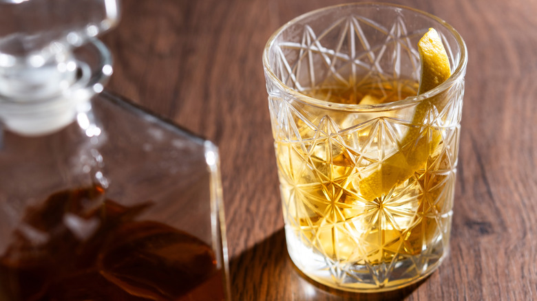A rusty nail cocktail in a rocks glass.