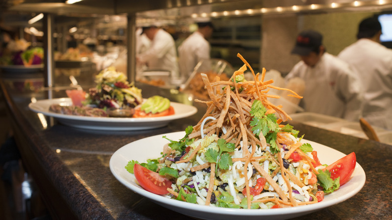 Salads being prepared by Cheesecake Factory chefs
