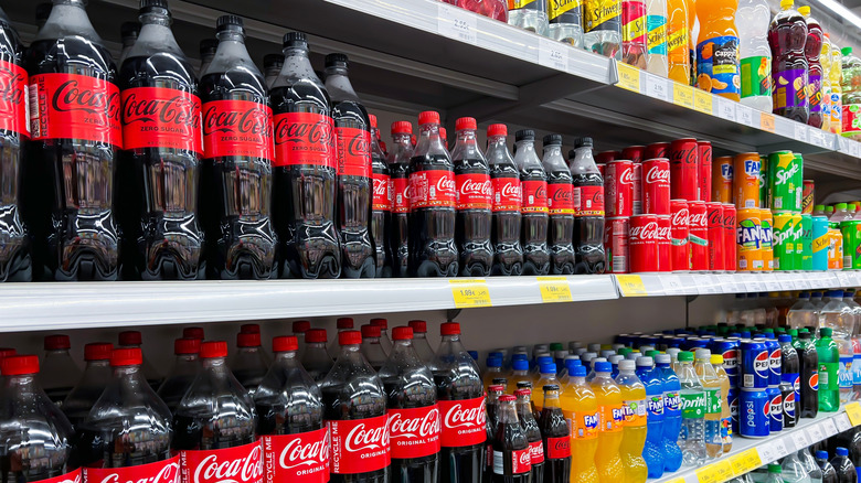 plastic Coca-Cola bottles lining shelf