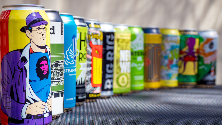 a row of various cans of craft beer