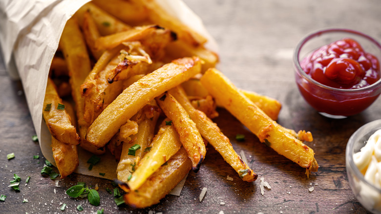 pile of french fries with dipping sauce