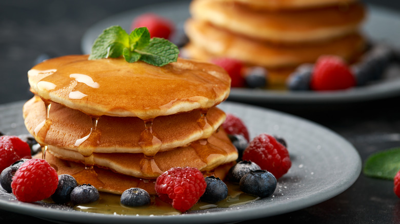 American style pancakes with honey, berries, and mint
