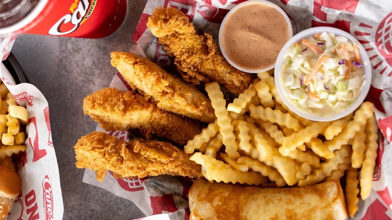 Basket of Raising Cane's chicken, sides, sauce, and drink