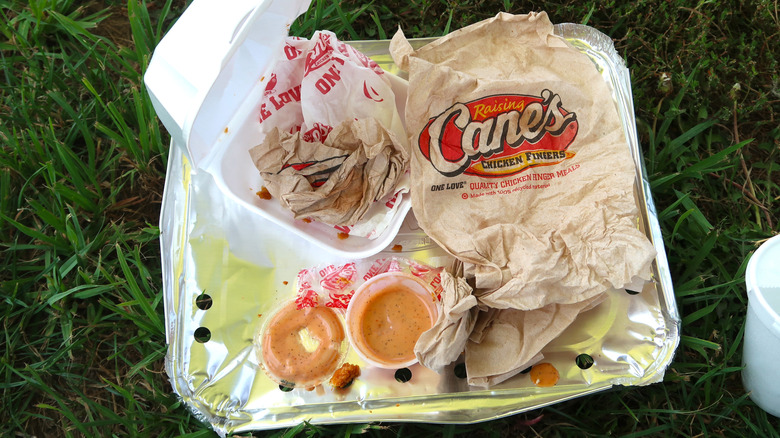 A finished meal from Raising Cane's on a lawn