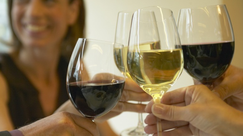People raising wine glasses