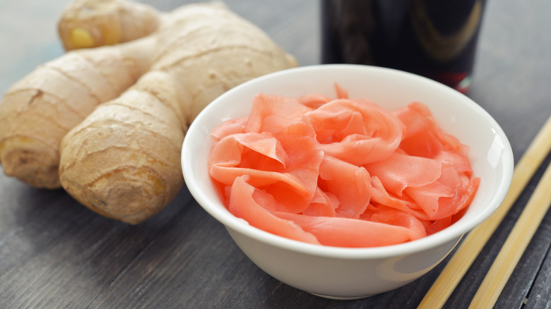 Bowl of pickled ginger next to root