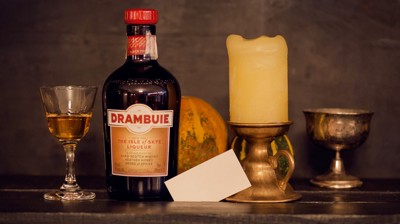 Bottle of Drambuie with candle and chalices