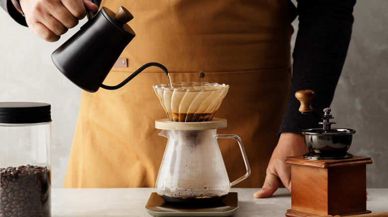 Person making coffee in a drip coffee maker