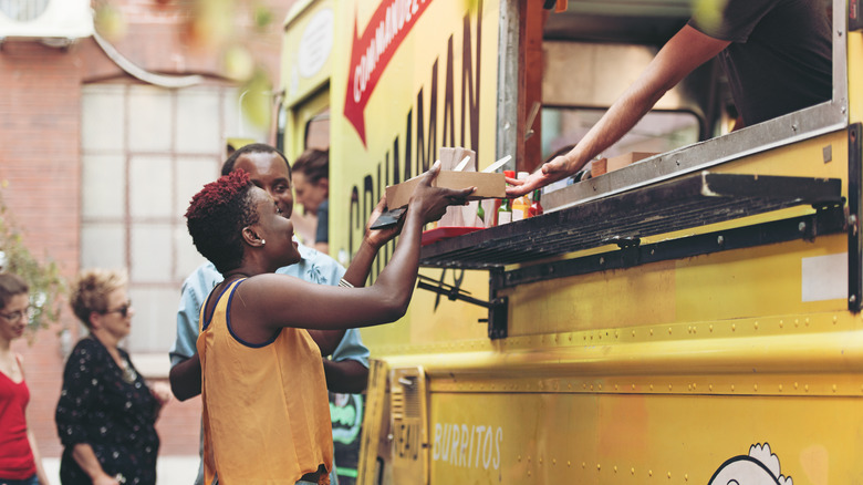 woman getting food from a food truck