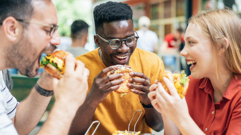 Friends eating burgers together