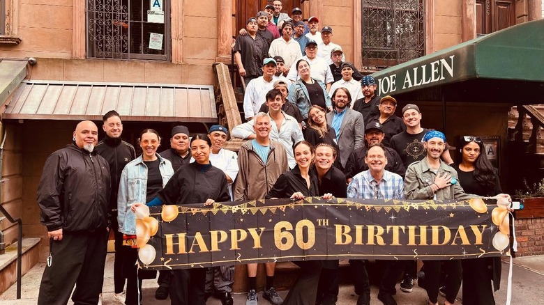 Employees of Joe Allen restaurant gather outside for its 60th birthday