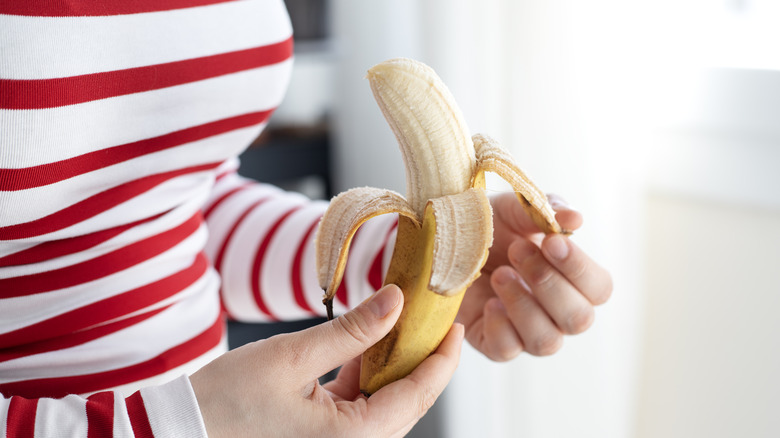 Person peeling a banana