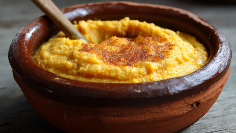 Cornmeal mush topped with sugar in a bowl.