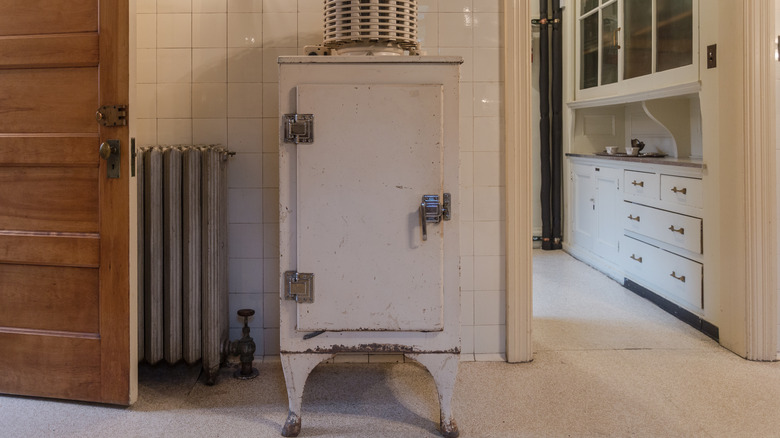 An ice box cabinet outside an old kitchen