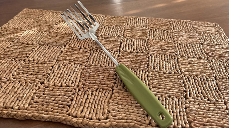 A Foley fork resting on a woven placemat