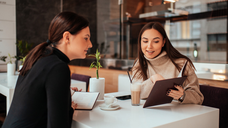 Women looking at a menu