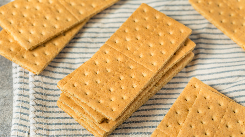 Several stacks of graham crackers lay on a cloth.