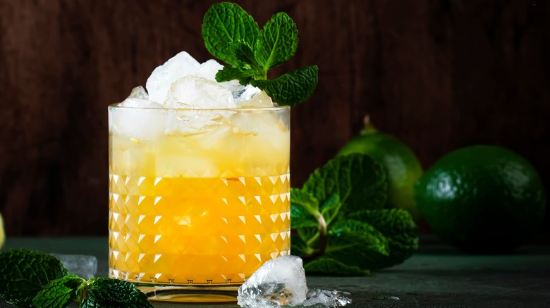 Yellow cocktail with mint garnish