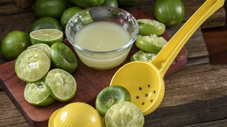 Cut limes and a juicer