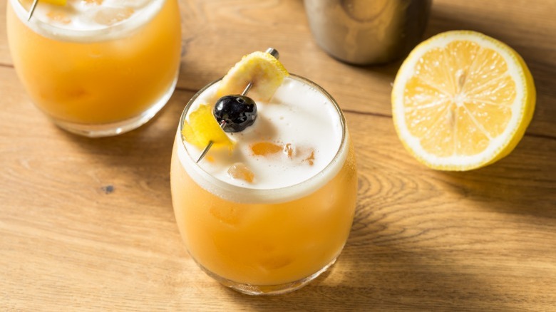 Amaretto sour cocktail garnished with lemon and a cherry