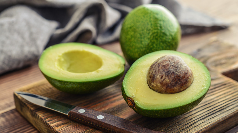 avocado cut on wood board