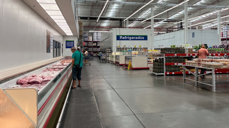 A shopper peers into the meat cooler of a Sam's Club location