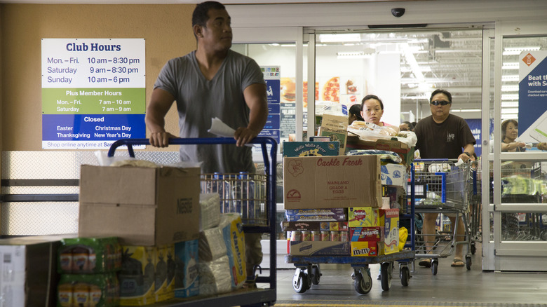 Shoppers with large carts exit Sam's Club location