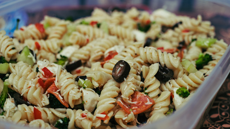 Pasta salad served in a takeout container.