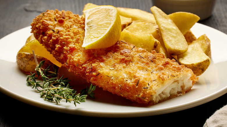Fish and chips served with lemon and herbs