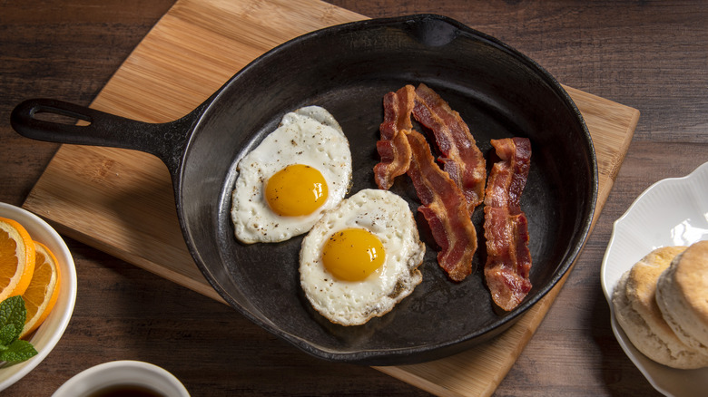 Fried eggs and bacon in a skillet for breakfast