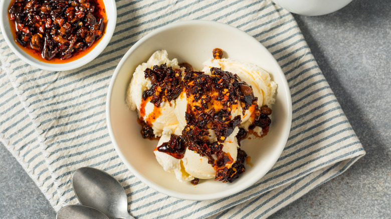 Ice cream in a bowl topped with chili crisp.
