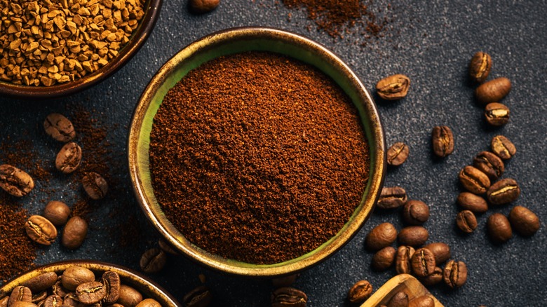 bowl of ground coffee with coffee beans