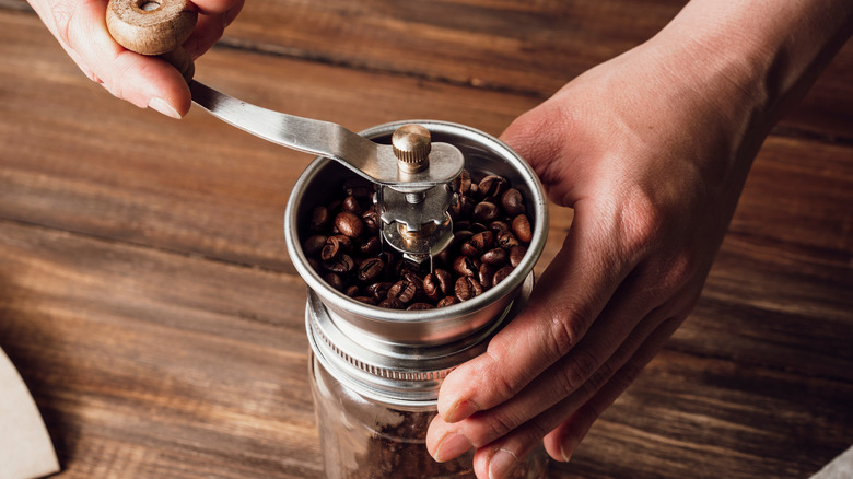 person grinding coffee beans