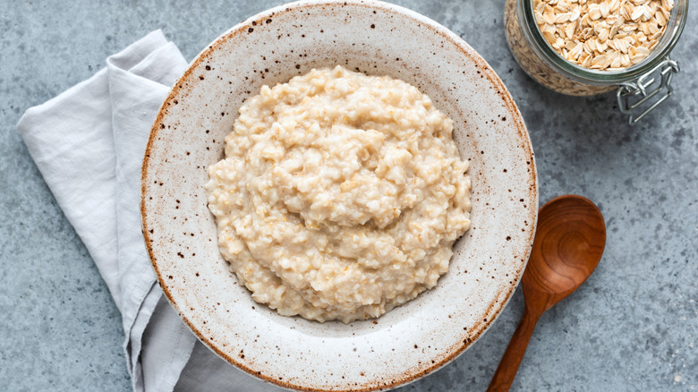 Oatmeal in a white bowl on a white background.