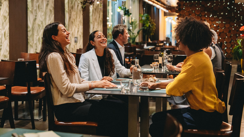 Happy people enjoying a lunch out together.