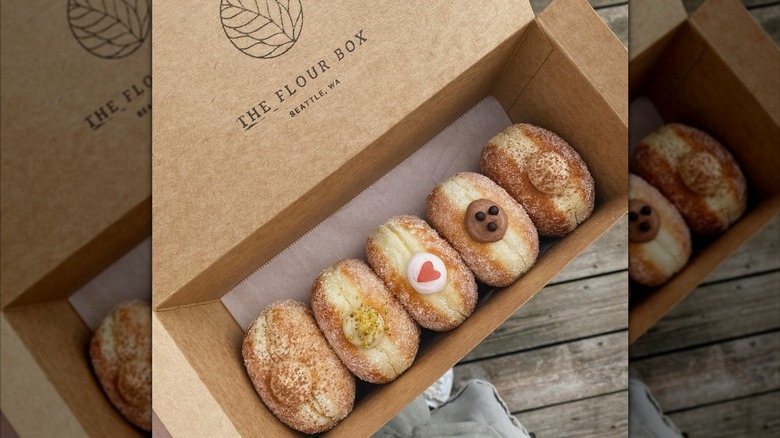 Filled donuts in a takeout container from The Flour Box.