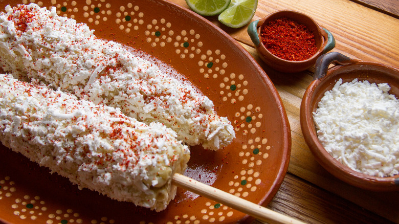 Mexican elotes on festive dinner plate