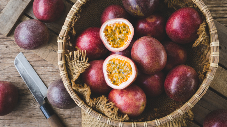 Bowl of passion fruit with knife