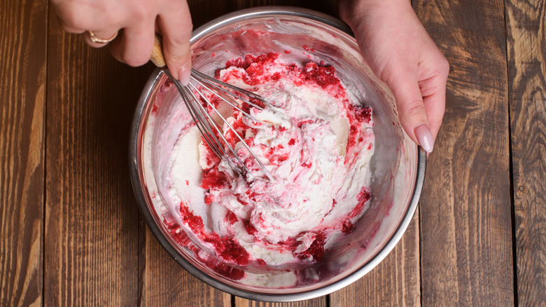 Home cook mixing a raspberry ice cream base by hand