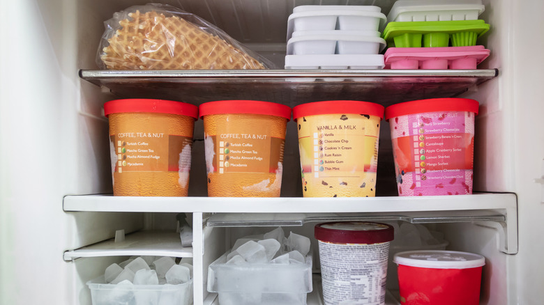 ice cream flavors and waffle cones in freezer