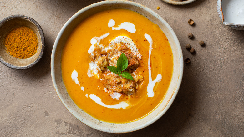 bowl of butternut squash soup with cream drizzle