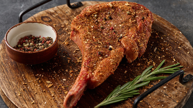 A spice-rubbed ribeye on a wooden board