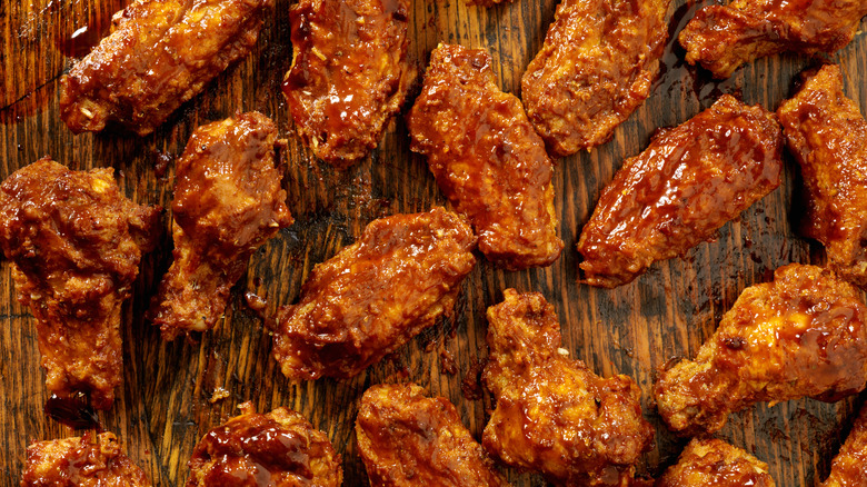 Chicken wings laid out on a wooden surface